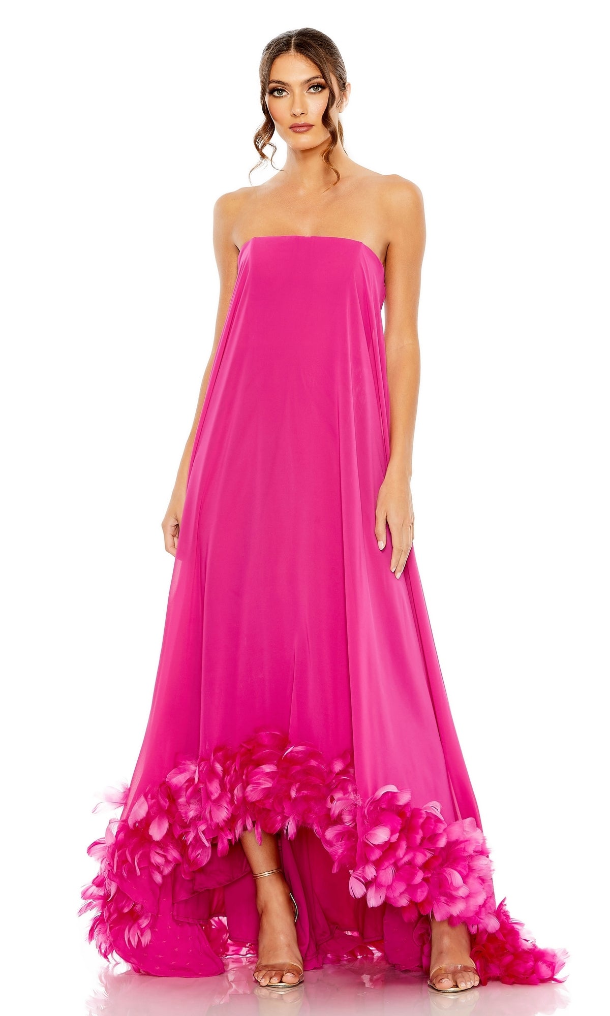 A woman models the Strapless Trapeze Formal Gown: Mac Duggal 13001, a bright pink, long strapless dress with feathered hem—an elegant evening gown perfect for prom—posed against a white background.